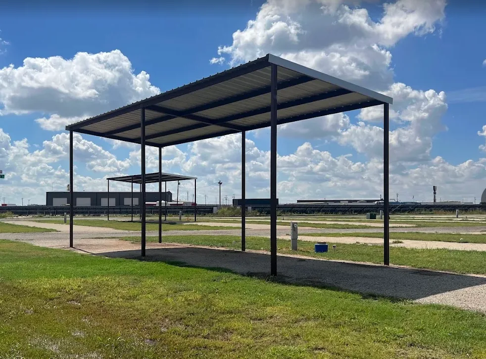 Tall steel canopy shading a covered RV pad