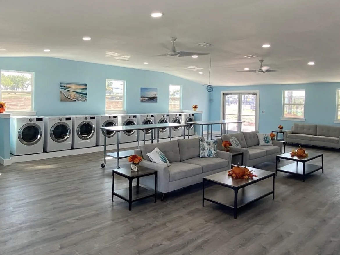 Tye RV Park laundry room with new washers and dryers and a seating lounge