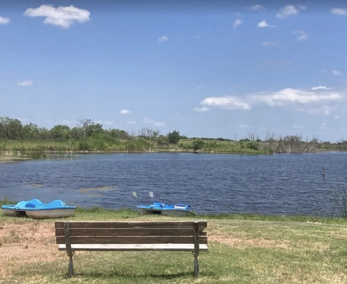 Catch-and-release fishing pond at Tye RV Park with pedal boats and a bench