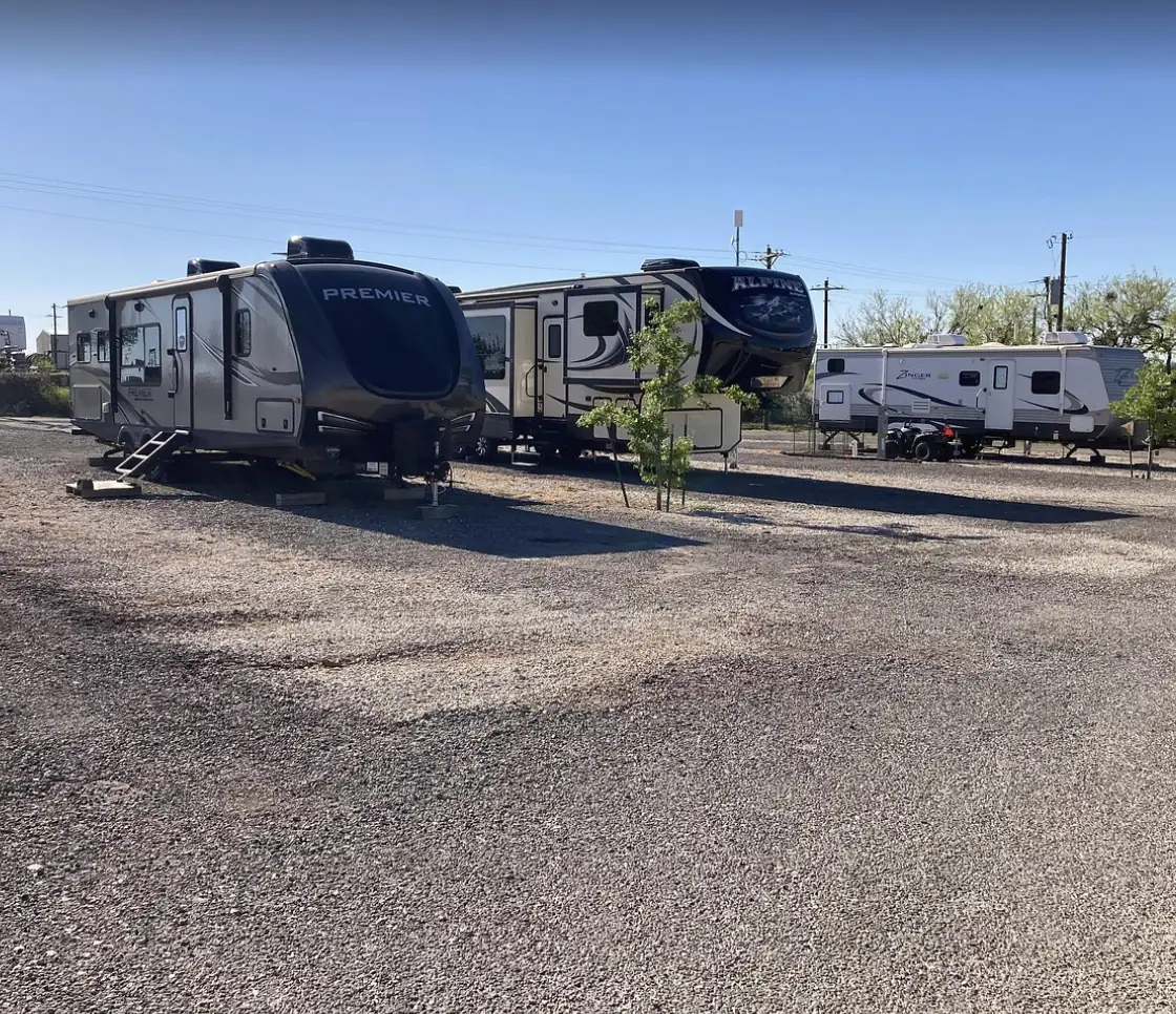 Graveled RV sites at Tye RV Park with travel trailers and fifth wheels parked